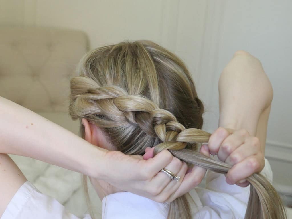 Continue your braid and across the second ear. Then, you have to round the back of your head, back towards your starting point. Moreover, continue the Dutch braid near your hairline until all hair is incorporated.